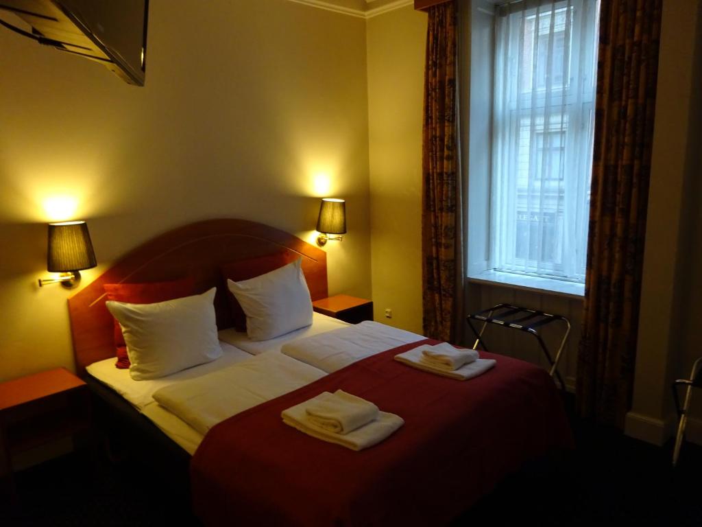 Postel nebo postele na pokoji v ubytování City Hotel Nebo
