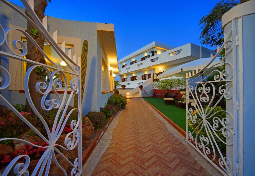 a walkway in front of a house at night at Iris Hotel in Ischia