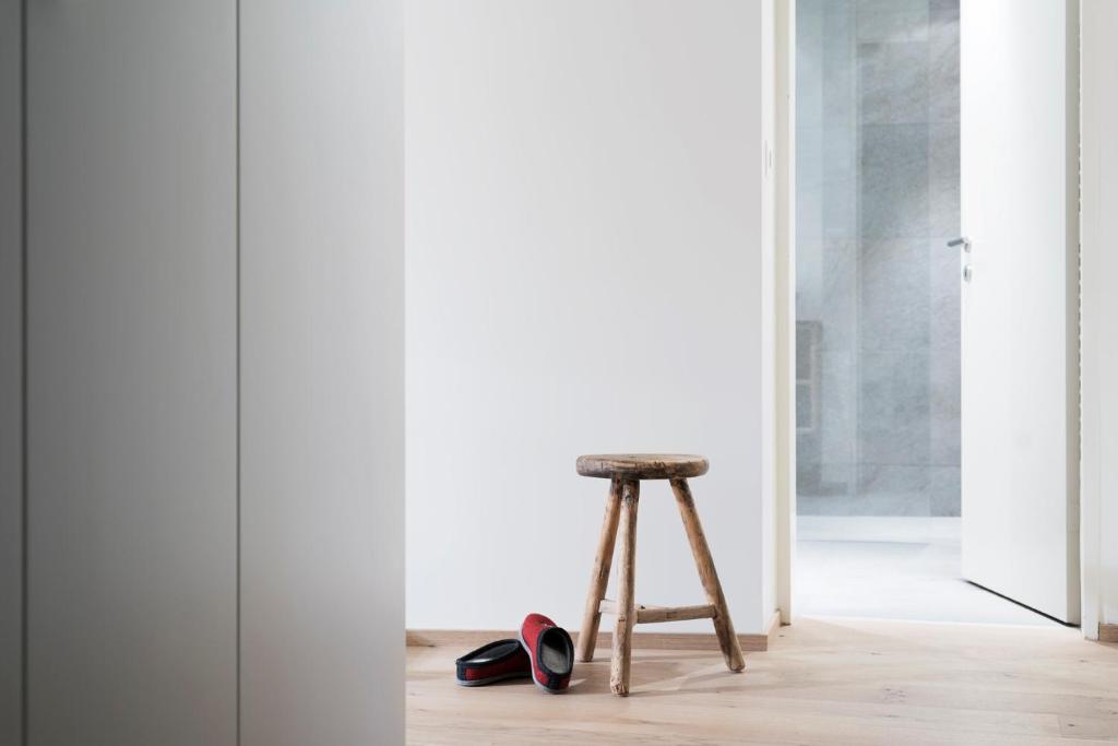 a stool and pair of shoes in a room at Haus-Ascot-Zermatt in Zermatt