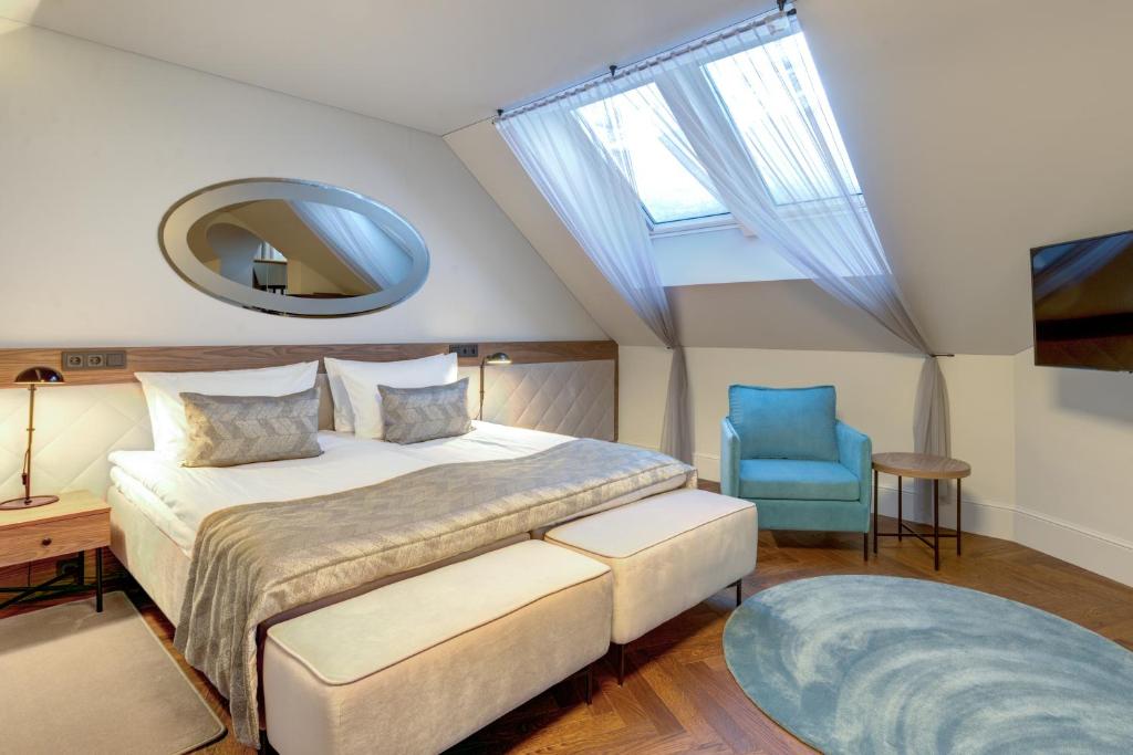 Postel nebo postele na pokoji v ubytování Hotel Vilnia