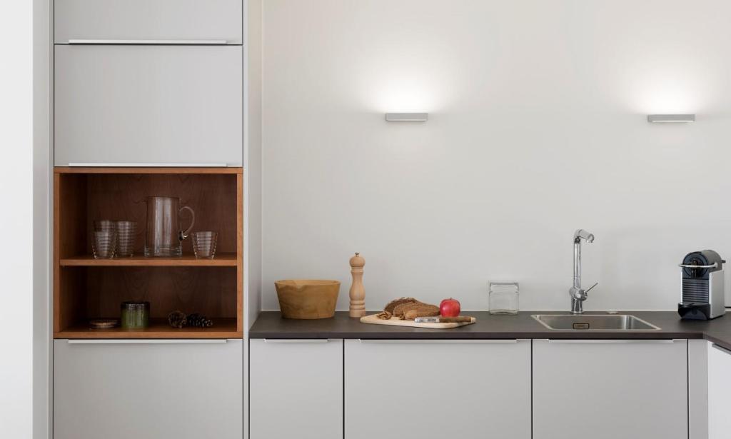 a kitchen with white cabinets and a plate of food at Haus-Ascot-Zermatt in Zermatt