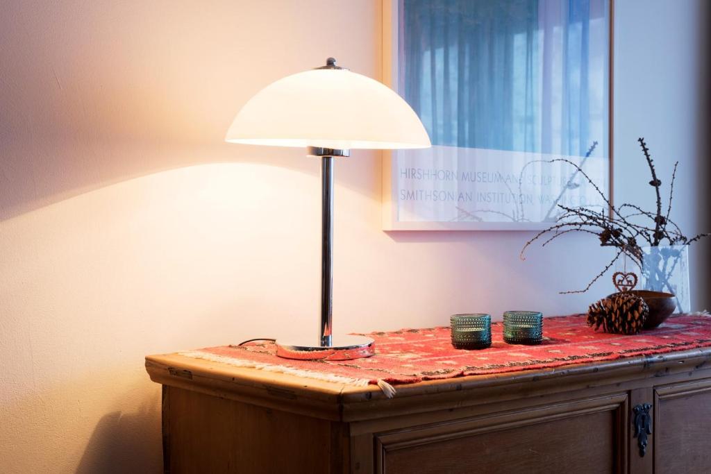 a lamp sitting on top of a wooden table at Haus-Ascot-Zermatt in Zermatt