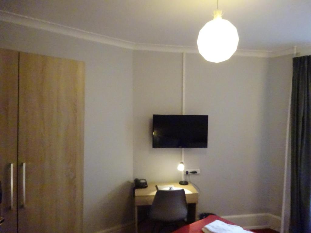 TV a/nebo společenská místnost v ubytování City Hotel Nebo