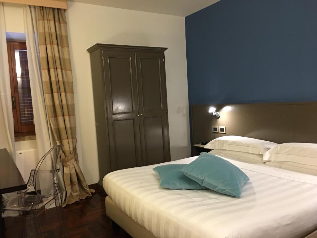 Postel nebo postele na pokoji v ubytování Locanda Giustini