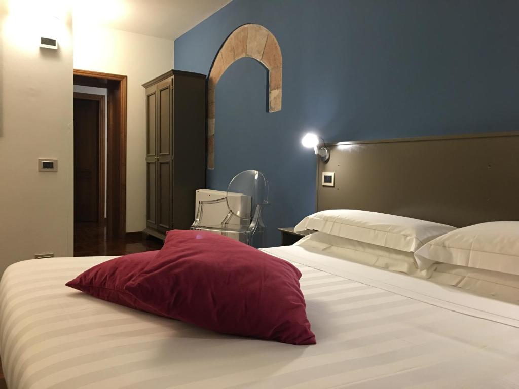Postel nebo postele na pokoji v ubytování Locanda Giustini