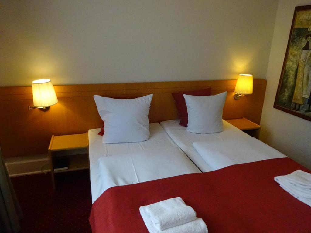 Postel nebo postele na pokoji v ubytování City Hotel Nebo