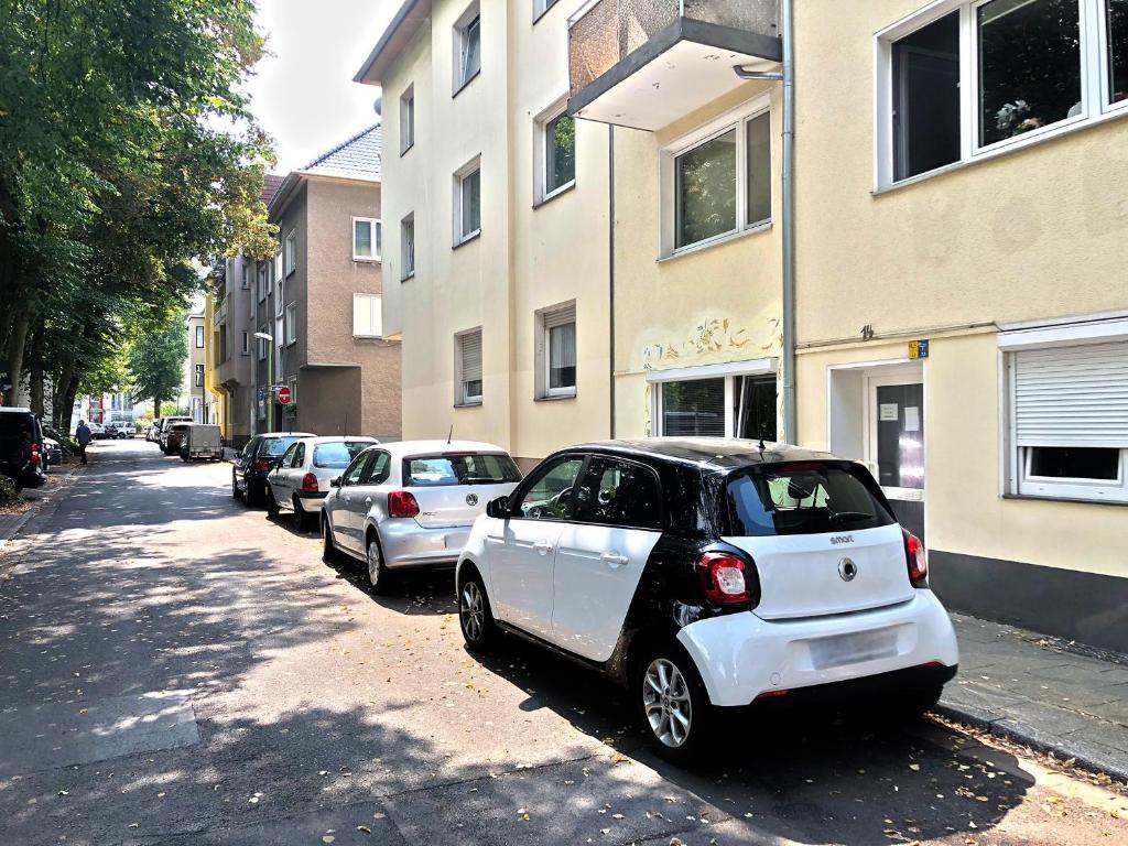 a small car parked on the side of a street at Apartments Essen-Rüttenscheid in Essen