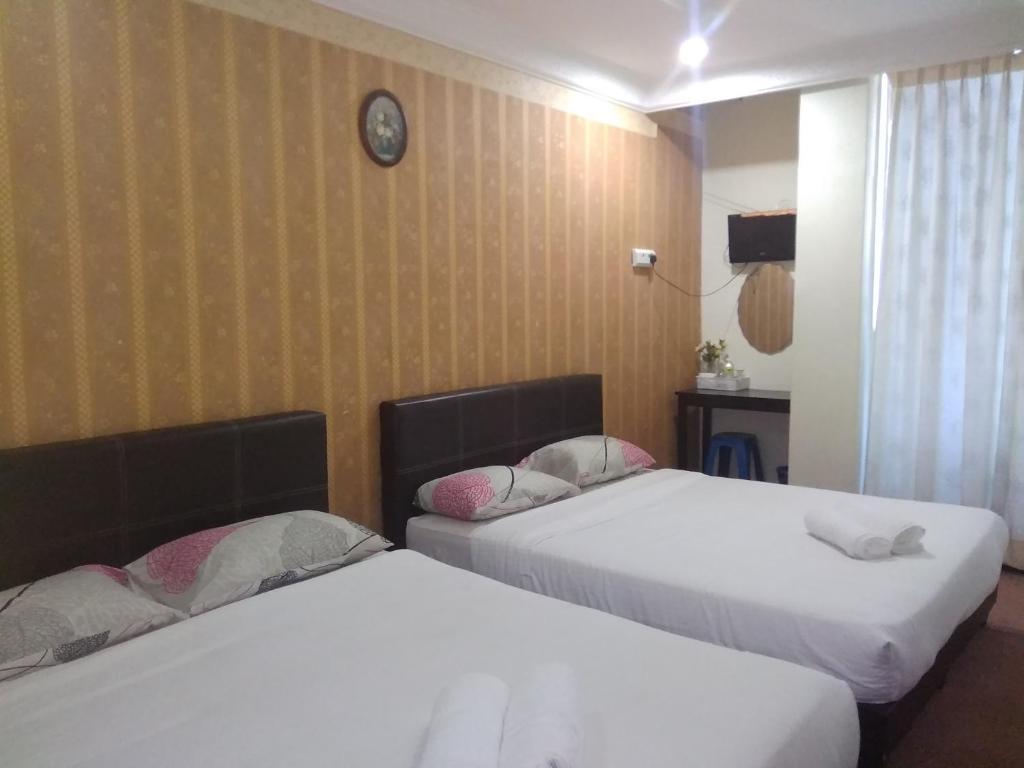 Postel nebo postele na pokoji v ubytování Hotel Tropicanna Pulai Point