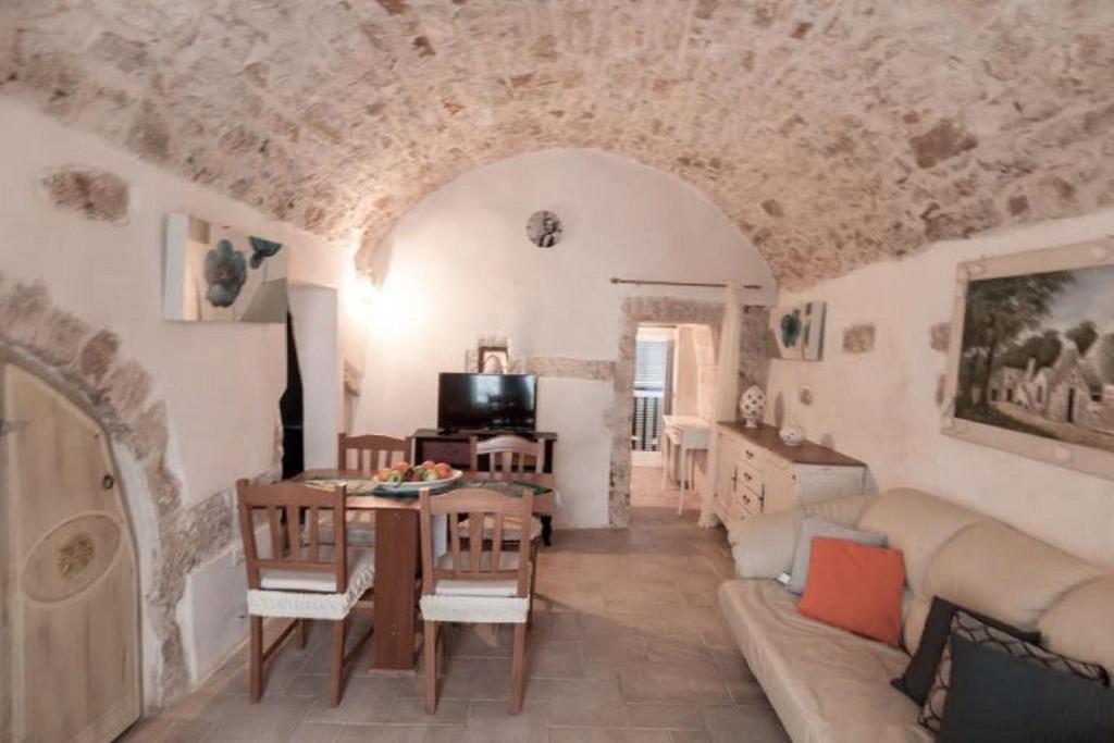 a living room with a couch and a table at THE GOODIES OF HISTORIC CENTER in Ostuni