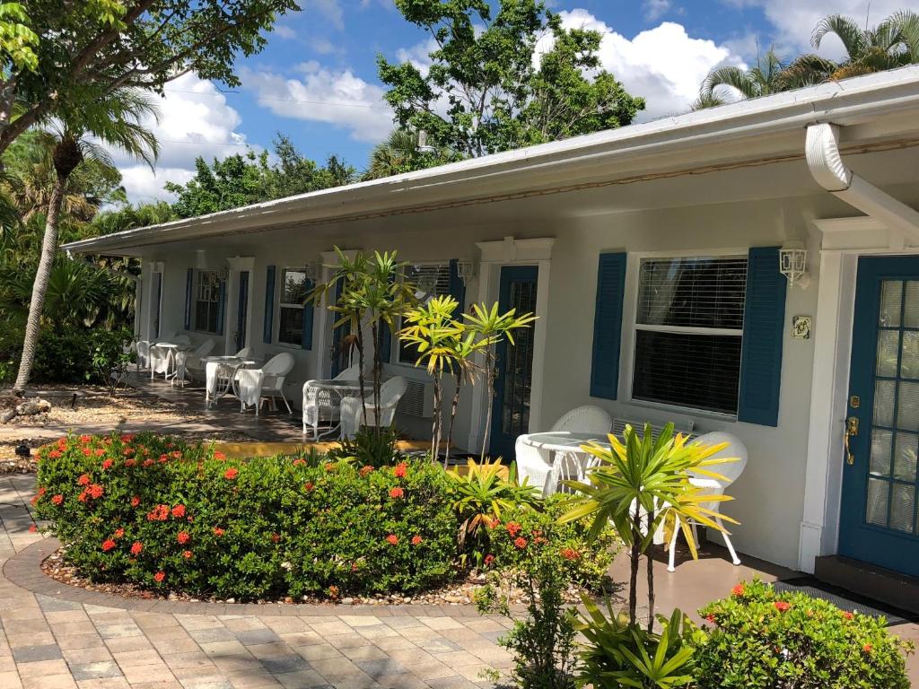 a house with chairs and flowers on a patio at Marco Island Lakeside Inn in Marco Island