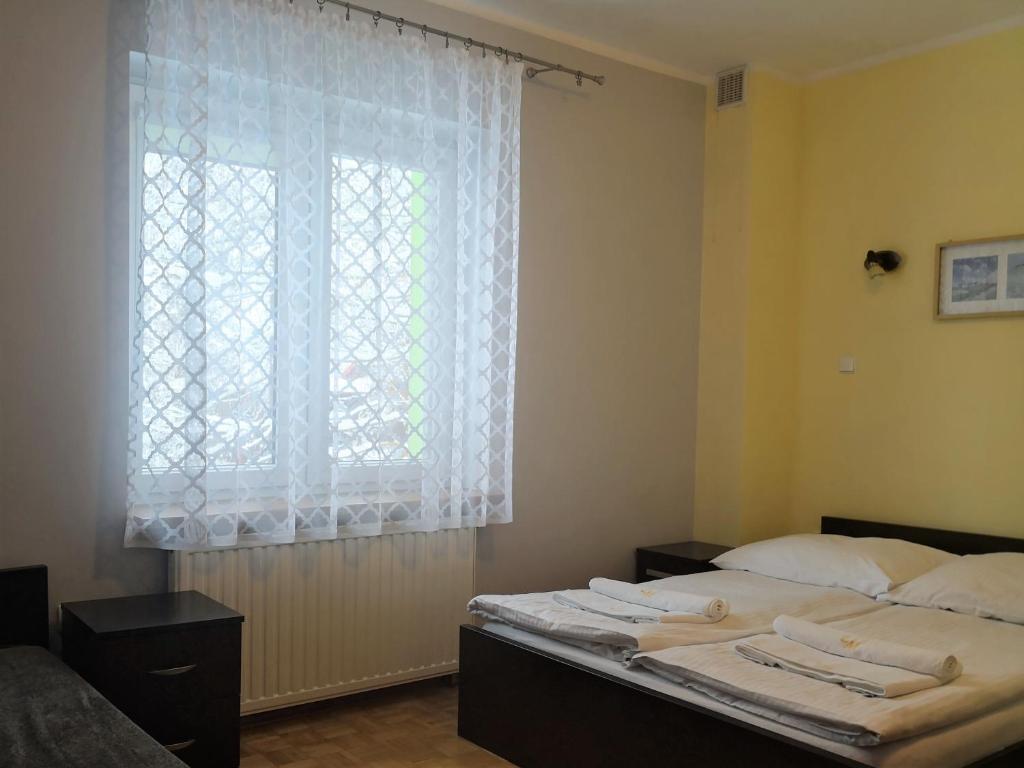 Postel nebo postele na pokoji v ubytování Leniwy Motyl