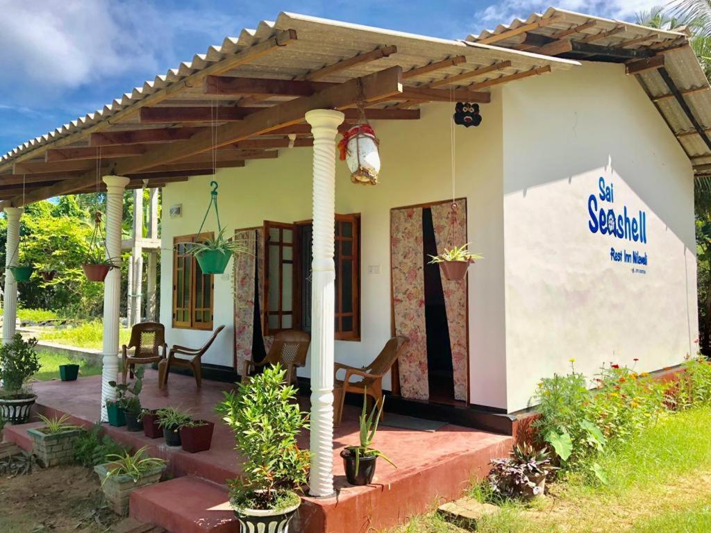 a small house with a pergola at Sai Seashell Rest Inn Nilaveli in Trincomalee