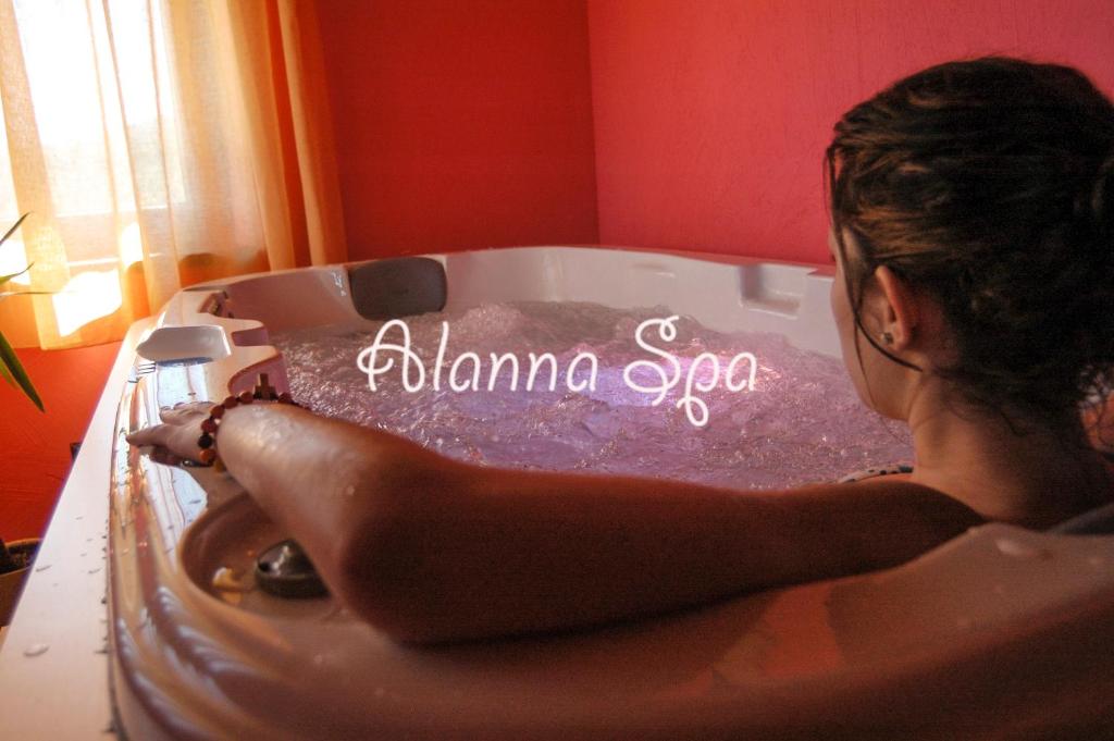 a woman sitting in a bath tub with the words karma spa at Casa rural Alanna Spa in San Bartolomé de Tormes