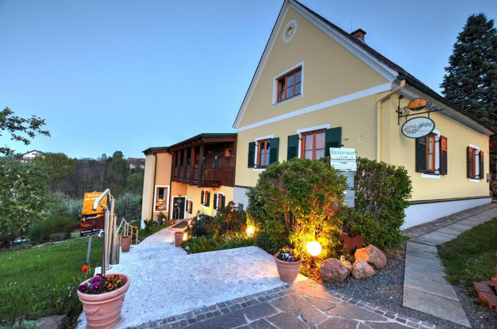 a house with a pathway leading up to it at FerienAppartments Landhaus FühlDichWohl in Fehring