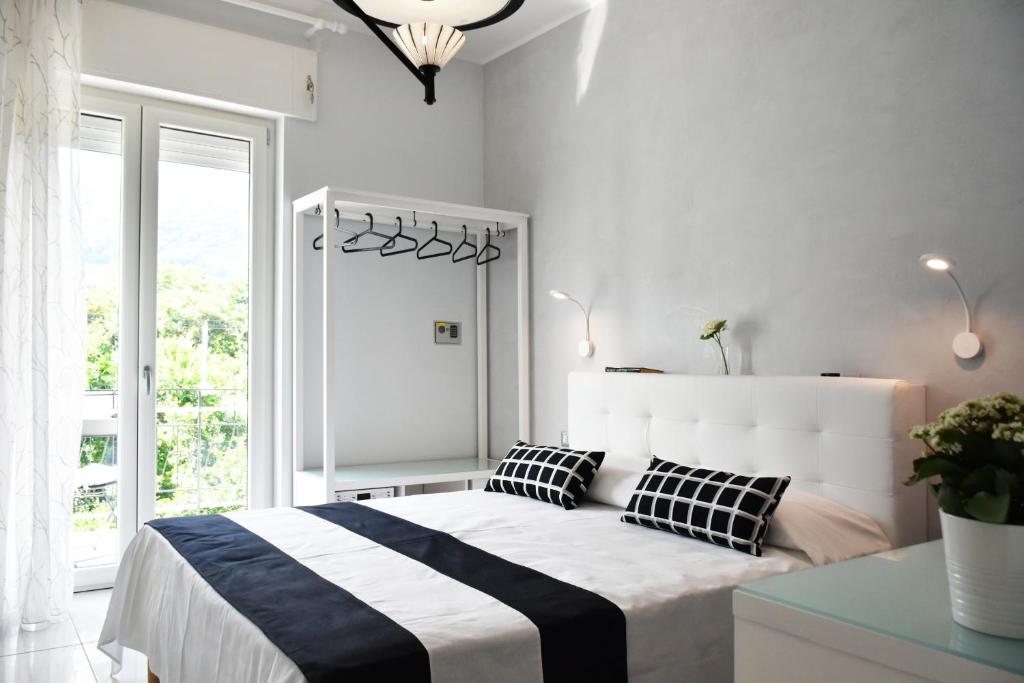 a bedroom with a bed with black and white pillows at Costantino Suites in Sorrento