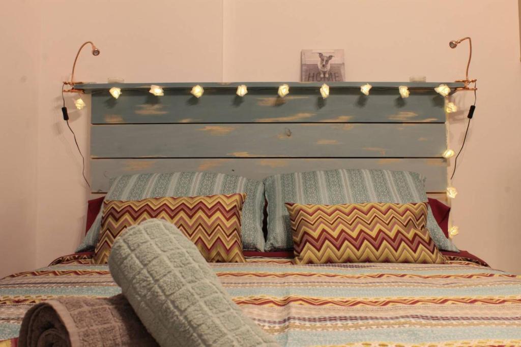 uma cama com uma cabeceira com luzes em Lovely Studio in the Heart of Malaga FREE SWIMMING POOL em Málaga