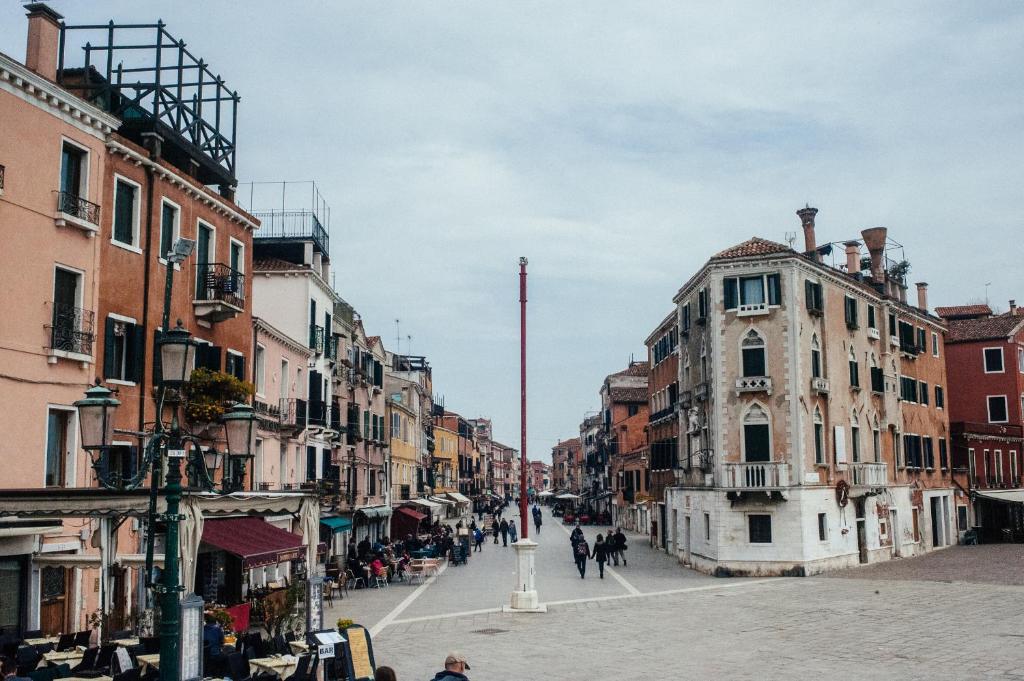 a city street with buildings and people walking down a street at Cà Grandi in Venice