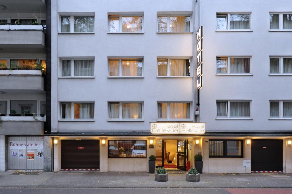 a white building with a sign in front of it at Bellevue Hotel in Düsseldorf