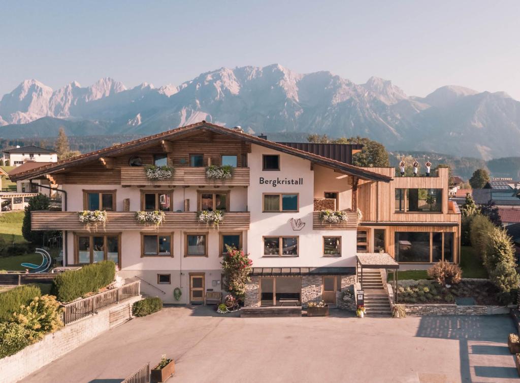 
a large building with a view of a mountain range at Bio Hotel Bergkristall in Schladming
