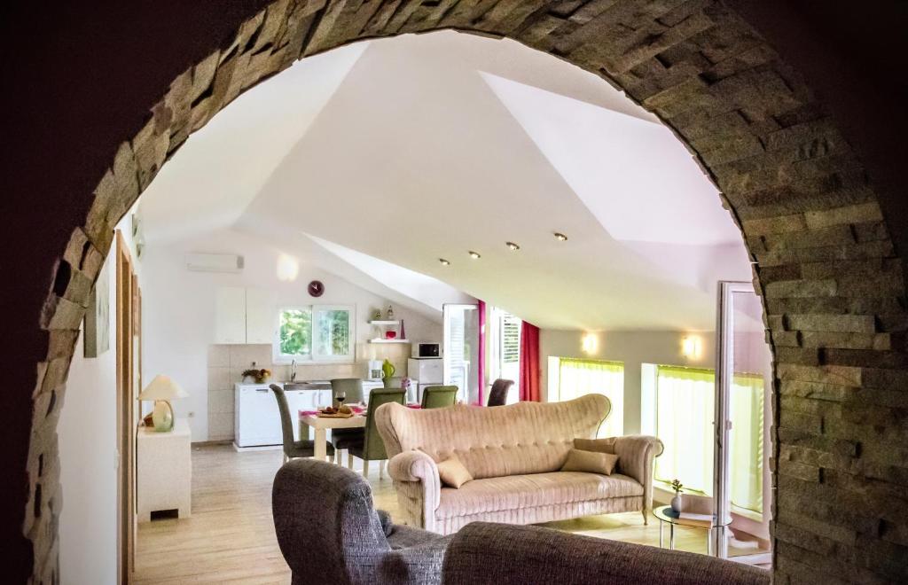 an archway in a living room with a couch at Apartments Velo Lago in Lastovo
