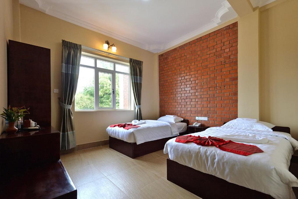 Llit o llits en una habitació de The Pegu Lodge