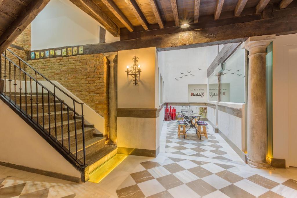 an open hallway with a staircase and a brick wall at Apartamentos Real Suites Realejo in Granada