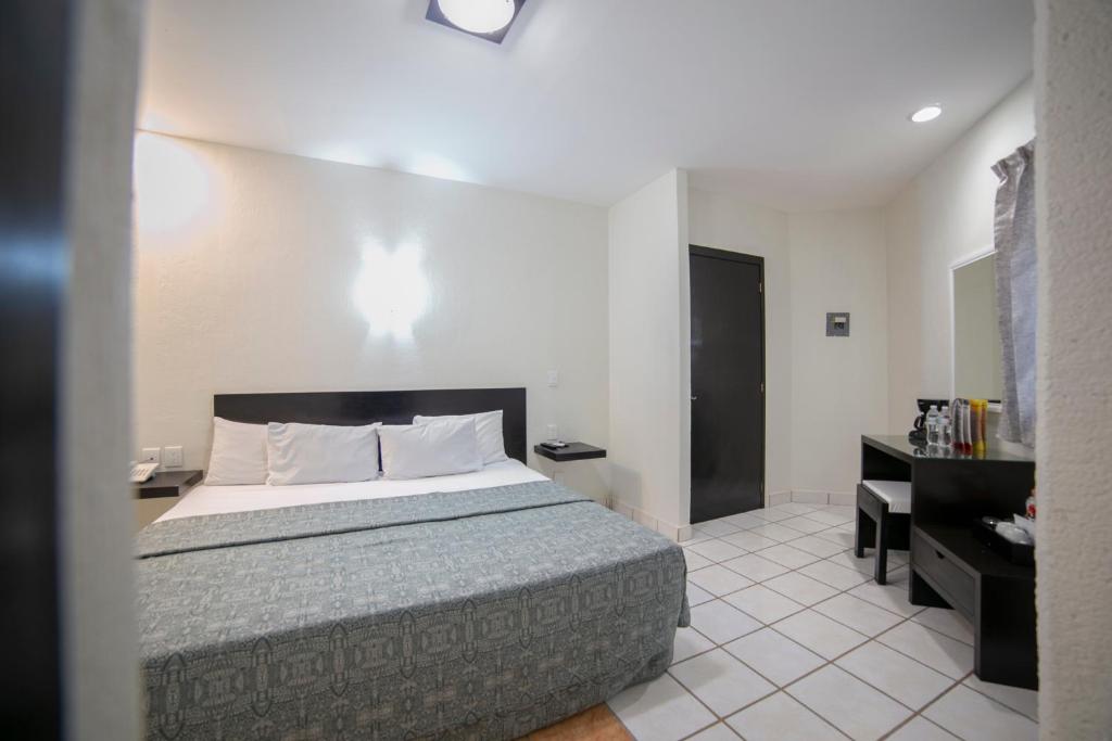 Postel nebo postele na pokoji v ubytování Hotel RS Suites