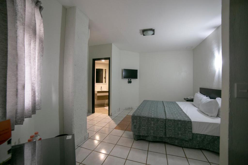 Postel nebo postele na pokoji v ubytování Hotel RS Suites