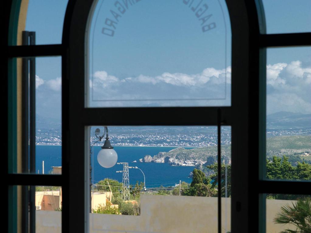 a window with a view of a body of water at Baglio Dello Zingaro in Scopello