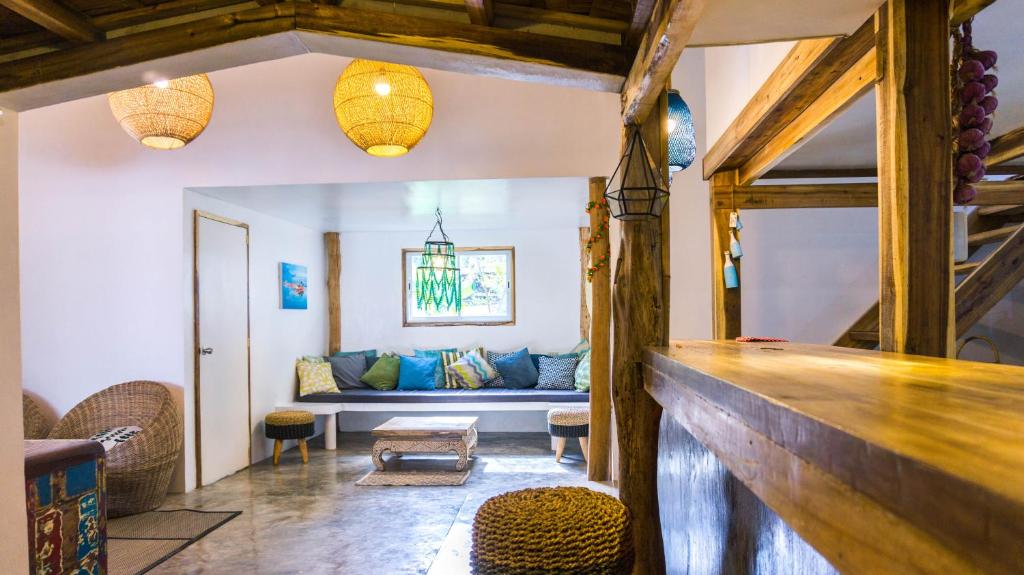 a living room with a couch and a table at Garden loft 90sqm in the heart of El Nido- 2 bedrooms in El Nido