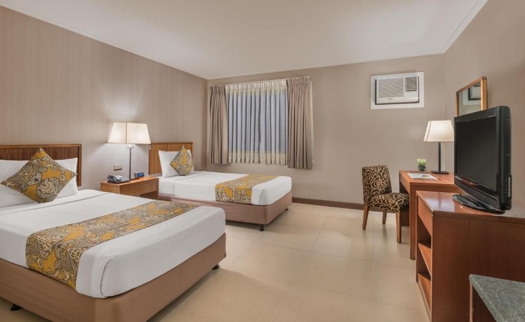 Postel nebo postele na pokoji v ubytování Hotel Kimberly Manila