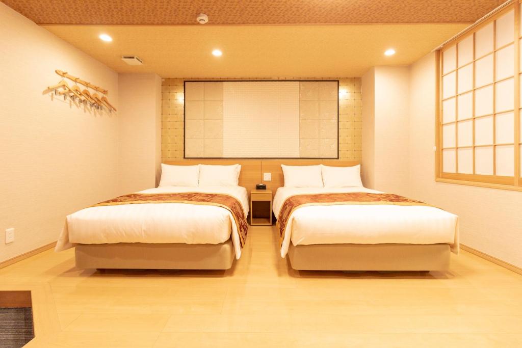 Postel nebo postele na pokoji v ubytování Nagomi Hotel Nippori