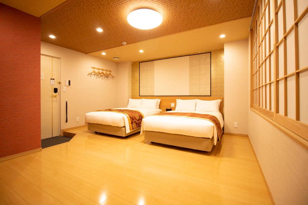 Postel nebo postele na pokoji v ubytování Nagomi Hotel Nippori