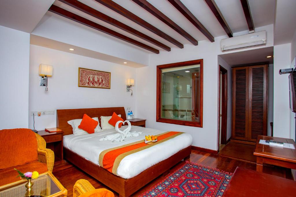 Postel nebo postele na pokoji v ubytování Apsara Boutique Hotel