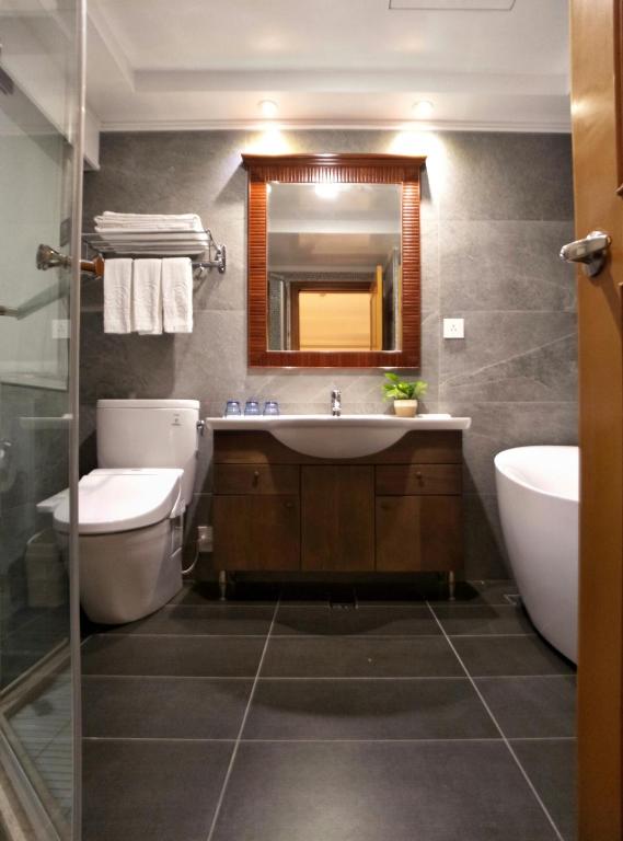 a bathroom with a sink and a toilet and a mirror at Beauty Hotels - Star Beauty Resort in Taipei