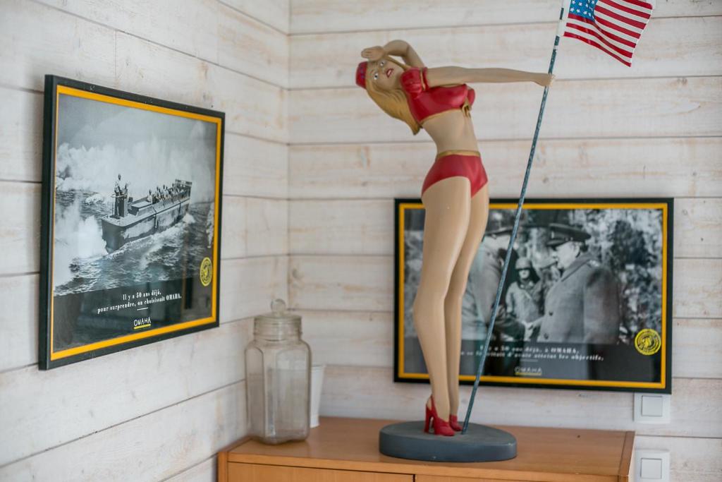 a statue of a woman in a swimsuit on a table at Les Costils in Saint-Laurent-sur-Mer