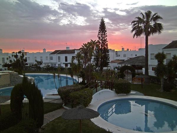 a view of two swimming pools in a resort at Precioso duplex con piscina in Chiclana de la Frontera
