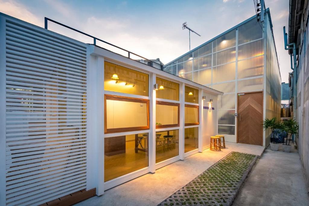 a house with glass walls and a patio at MORN-ING HOSTEL in Lat Krabang