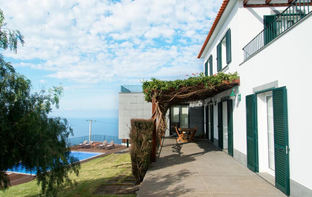 a house with a view of a swimming pool at Casa da Manta in Fajã da Ovelha