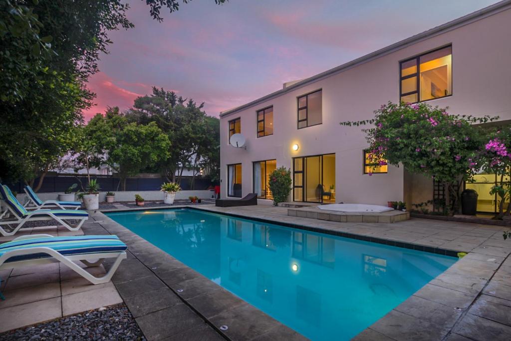 a swimming pool in the backyard of a house at Atlantic Bay Lodge in Cape Town