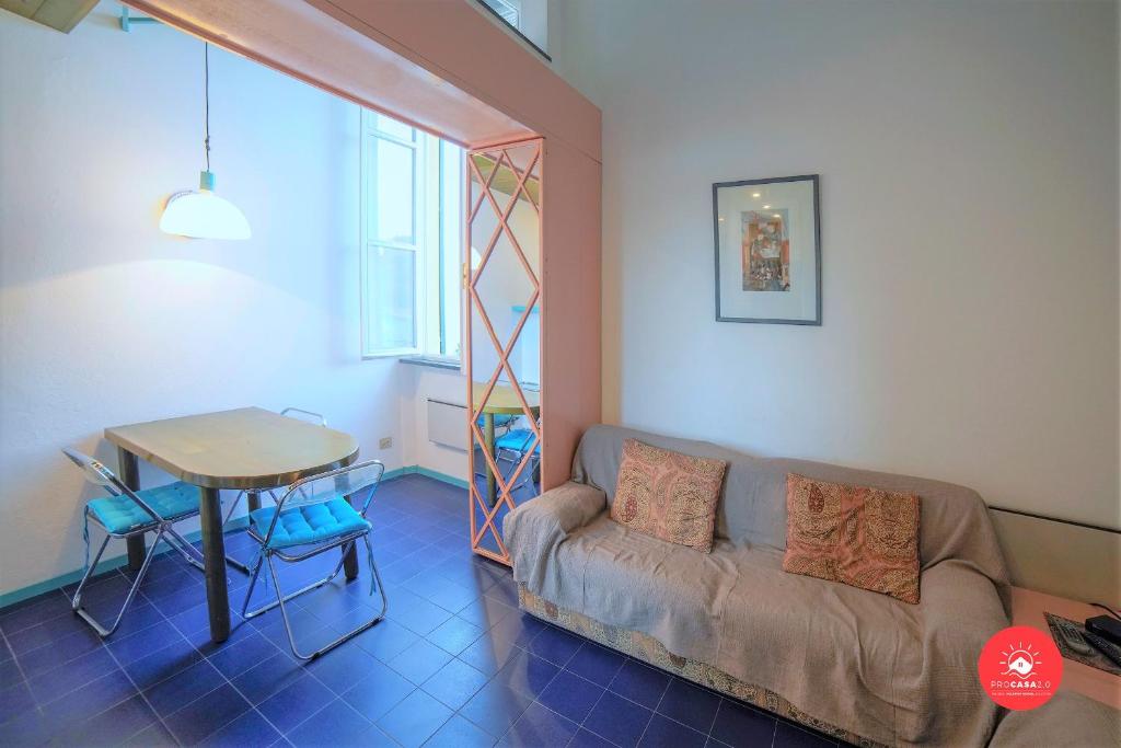 a living room with a couch and a table at La Finestra sul Mare in Portovenere
