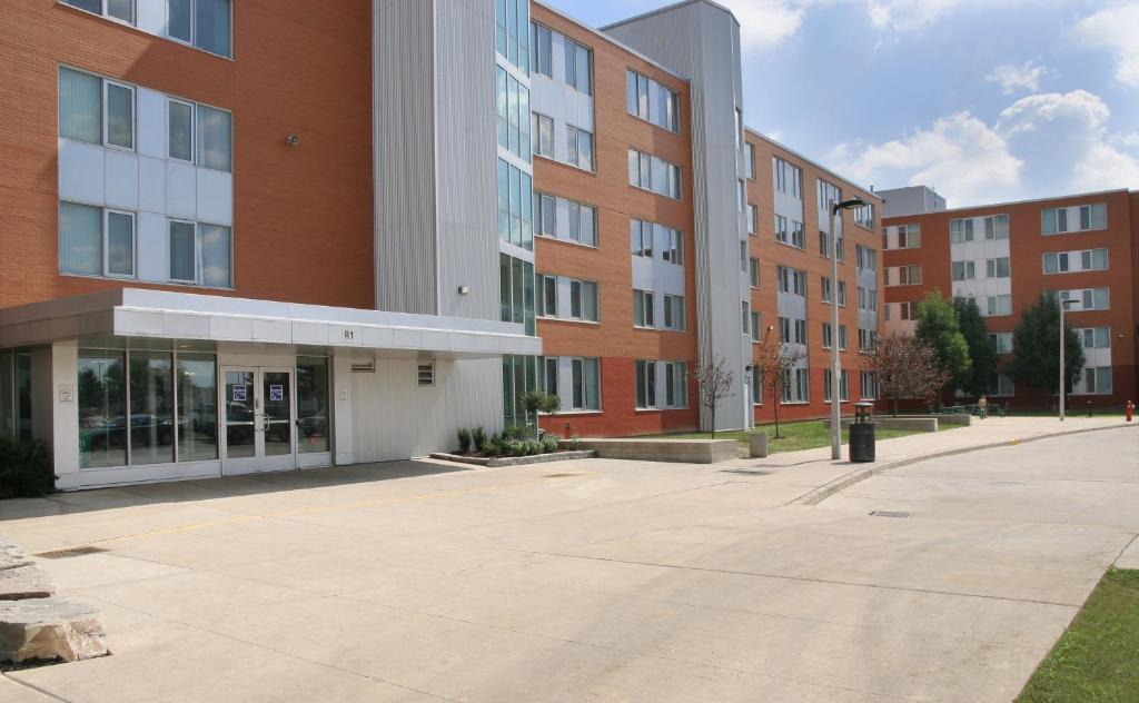 an empty parking lot in front of a building at Residence & Conference Centre - Brampton in Brampton