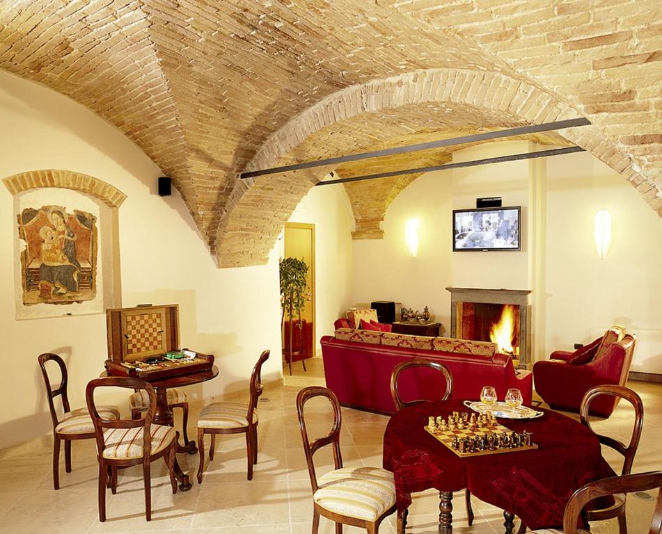 a living room with a couch and a table with chess at Hotel Italia in Foligno