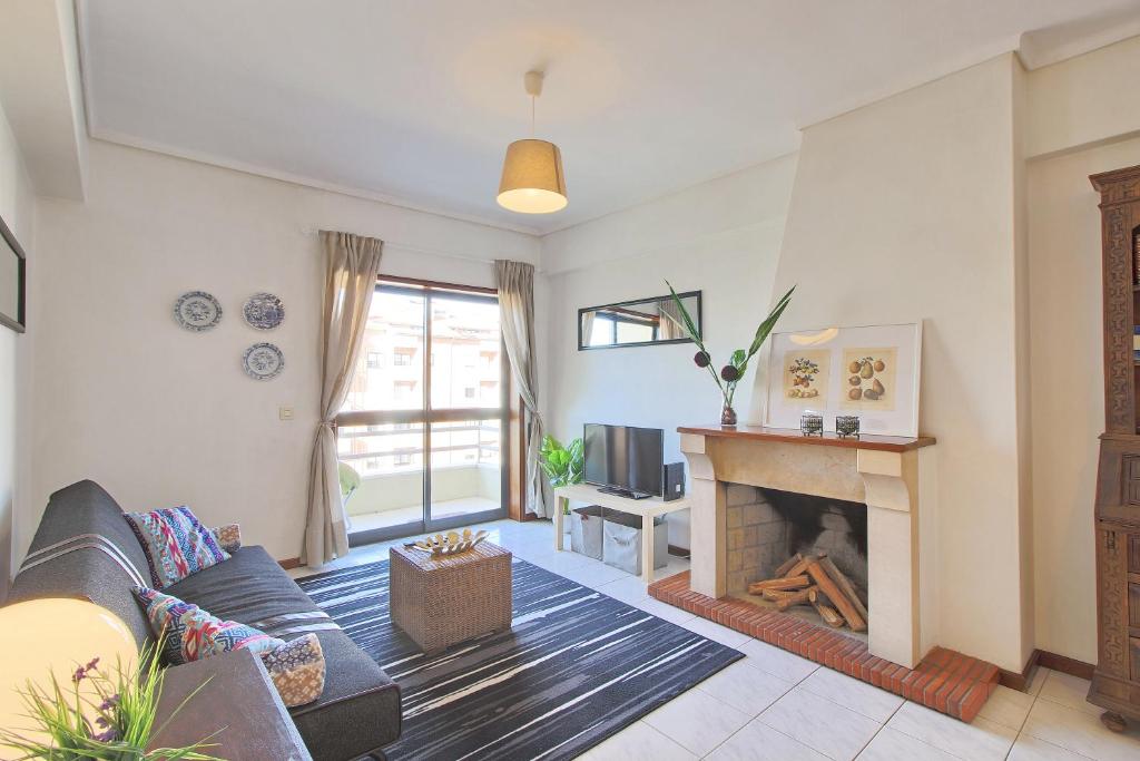 a living room with a couch and a fireplace at SResende Place Aveiro in Aveiro
