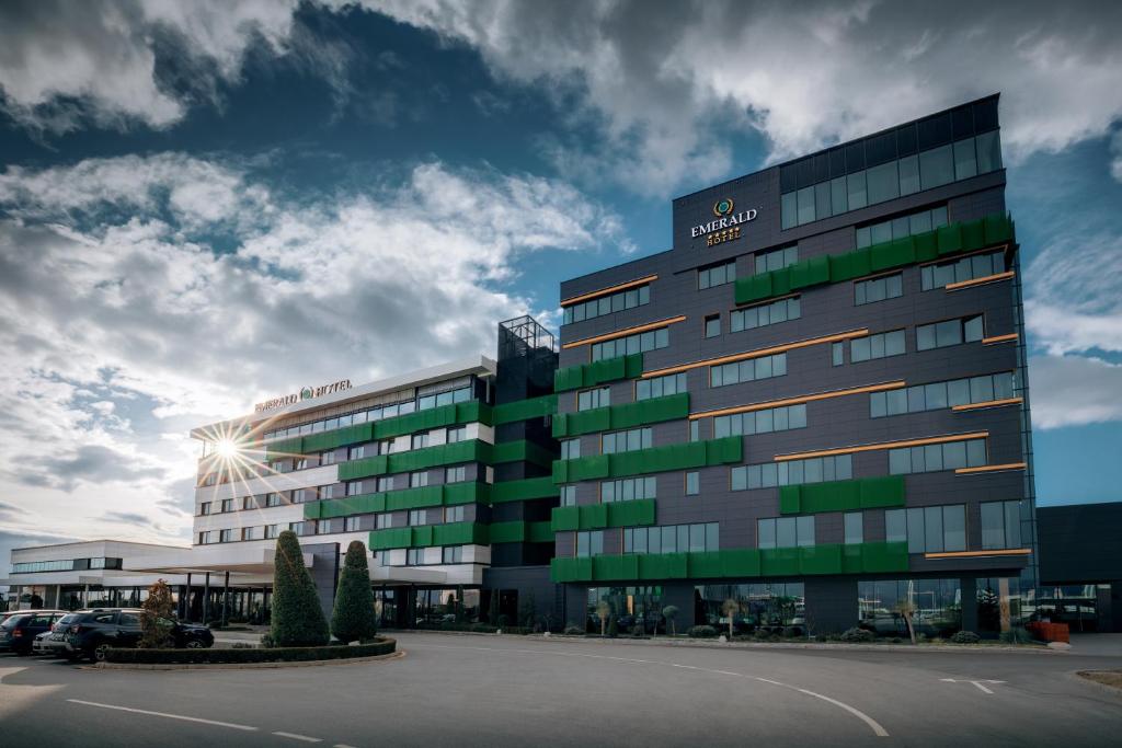a building with a sign on the side of it at Emerald Hotel in Prishtin&euml;