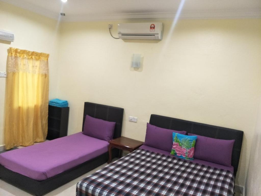 Postel nebo postele na pokoji v ubytování Motel Aurora Damai
