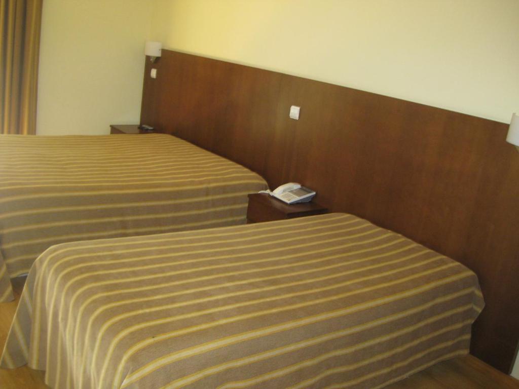 Postel nebo postele na pokoji v ubytování Hotel Minho Belo