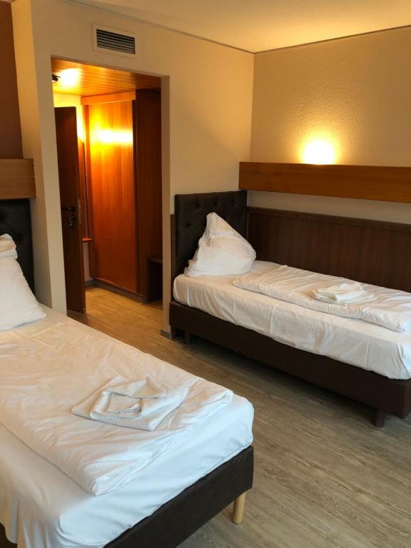 Postel nebo postele na pokoji v ubytování Hotel Poseidon