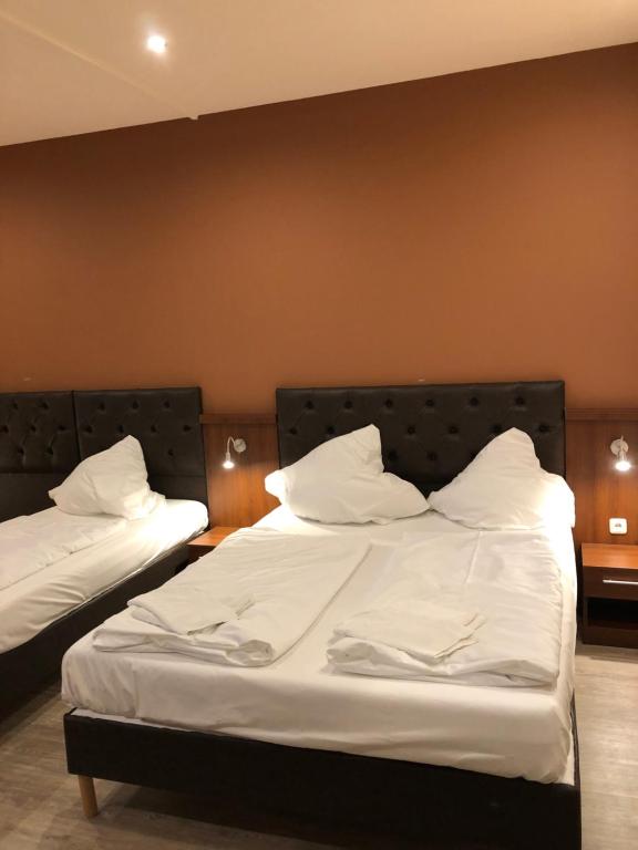 Postel nebo postele na pokoji v ubytování Hotel Poseidon