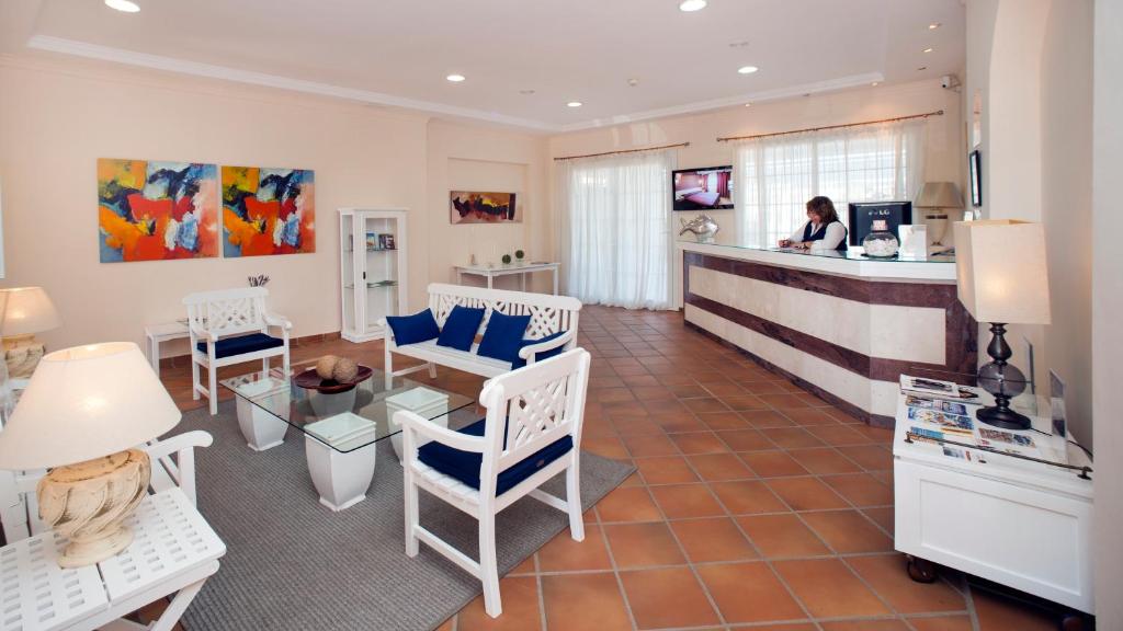 a woman standing at a counter in a salon at Leo San Bruno in Isla Canela